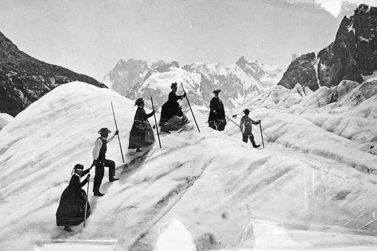 A group of men and women mountain climbing on the Mer de Glace, France, circa 1870
