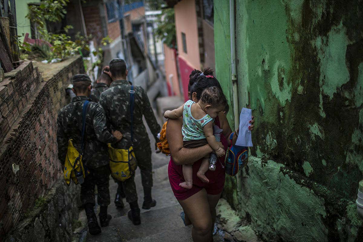 A woman and baby in a poor area of town