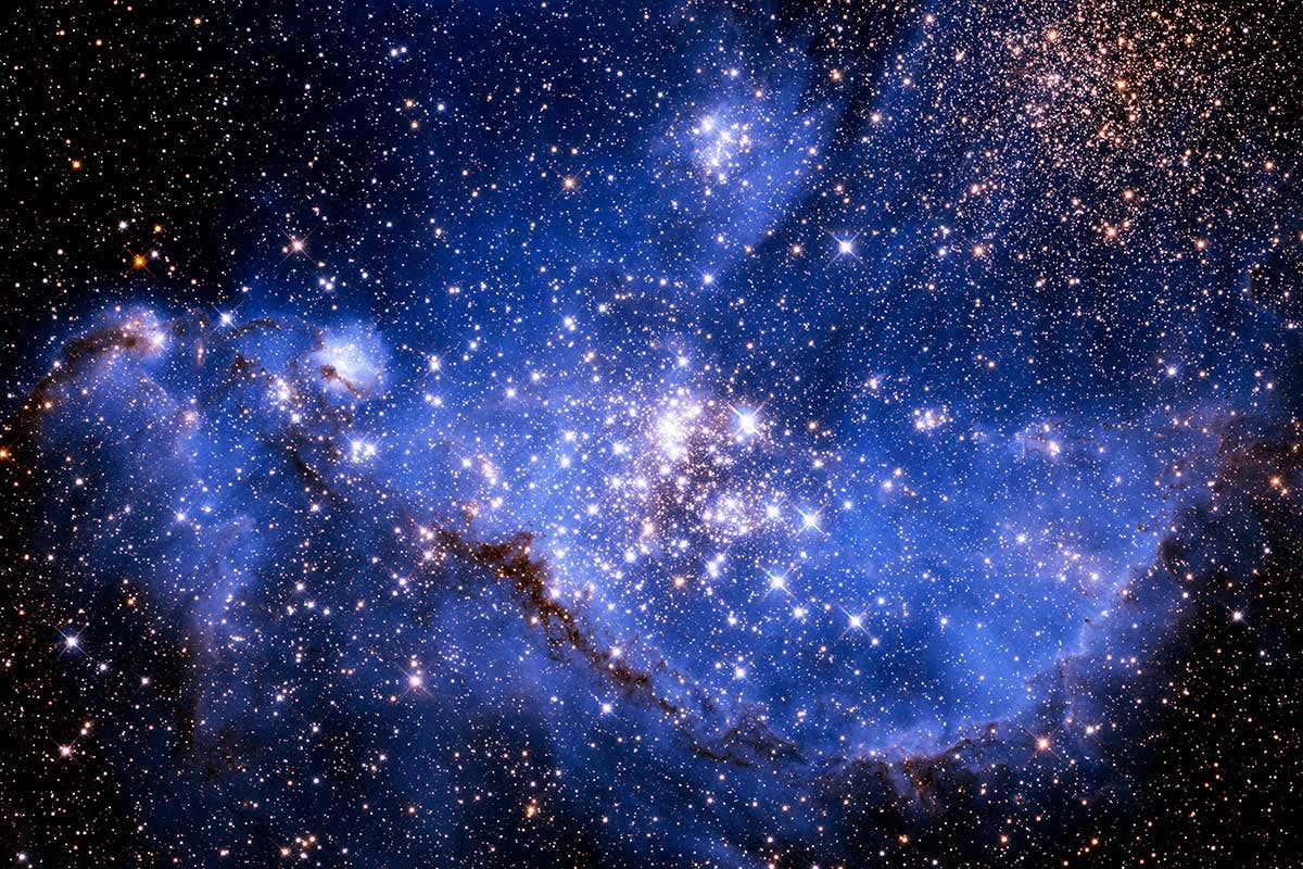 A pretty picture of lots of stars, large and small, with a cloudy blue backdrop presumably made of more stars