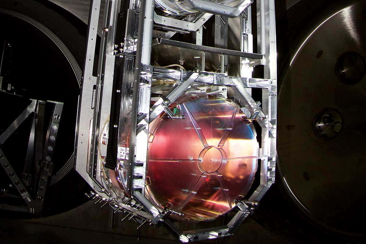 Red-tinted mirror suspended along with other objects