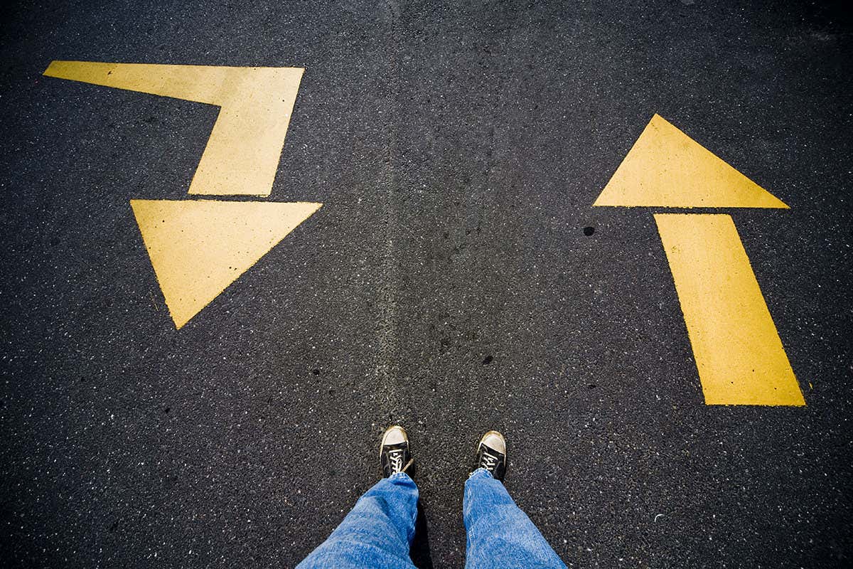 Picture of two feet and two arrows going in the opposite direction