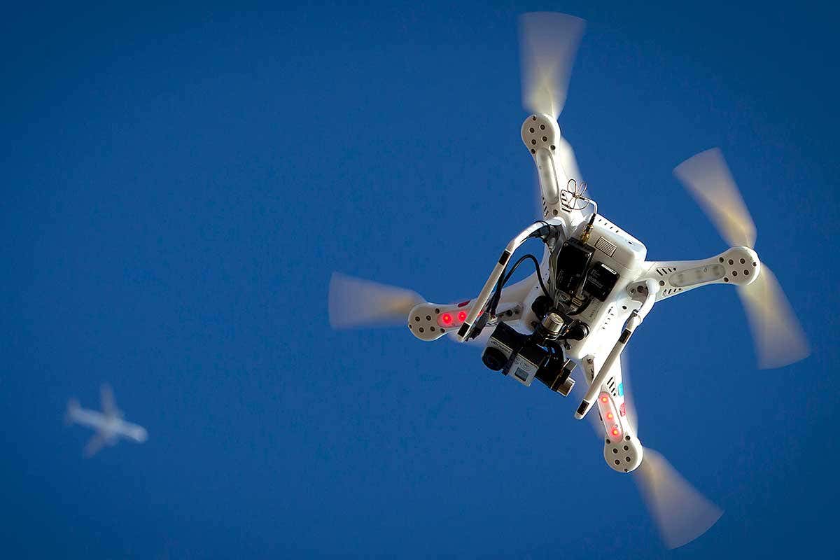 A quadcopter style drone in the sky