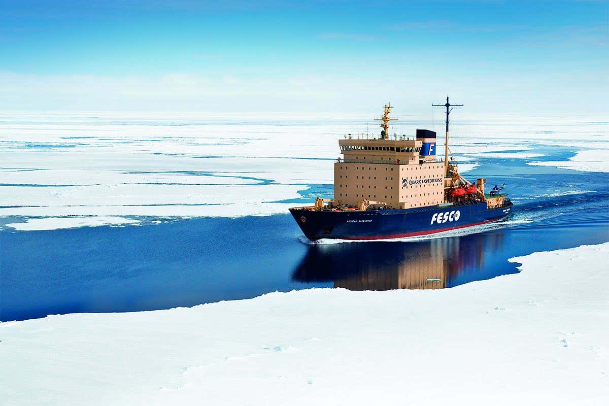 Icebreaker ship Kapitan Khlebnikov sailing through a channel in the ice