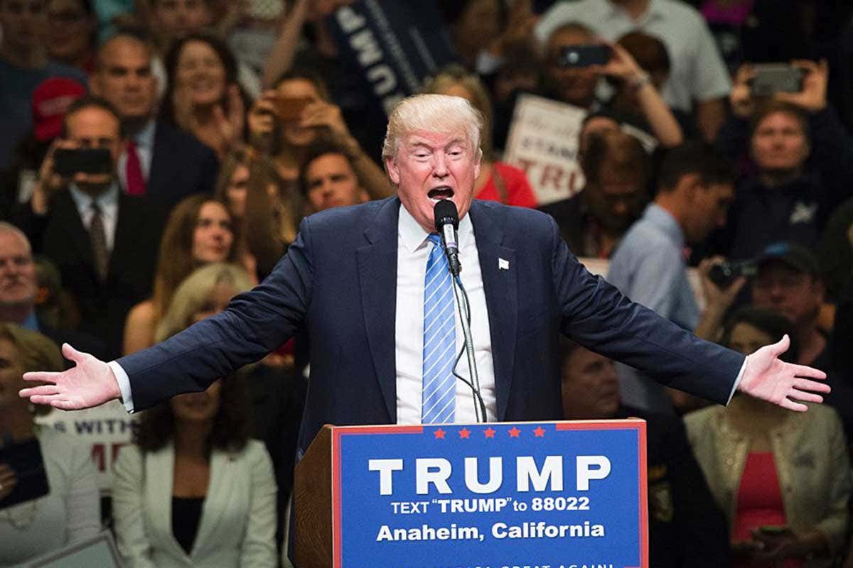 Trump on a podium, with his hilarious hair