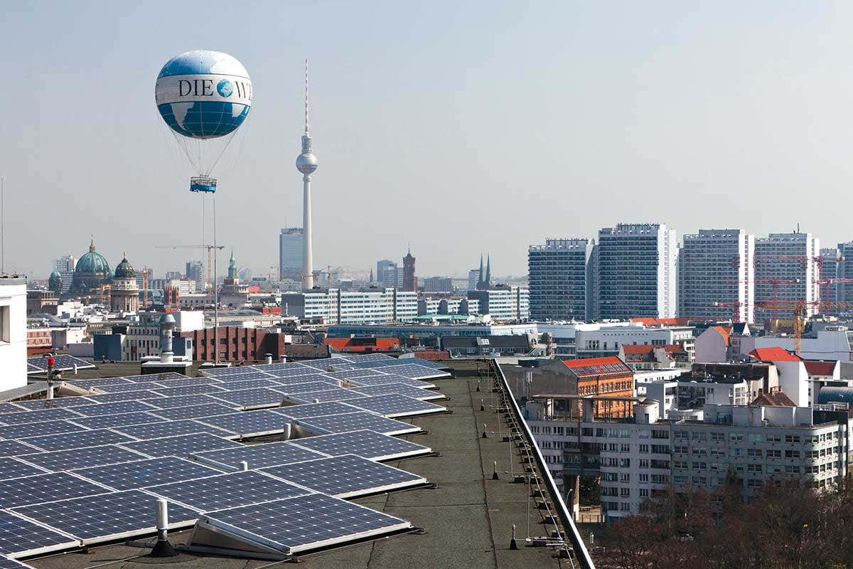 City rooftops showing solar panels