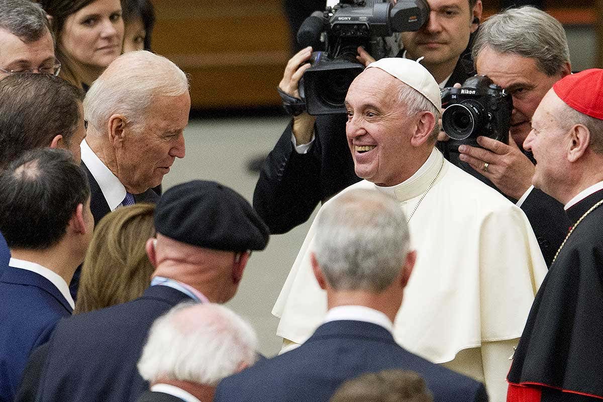 Joe Biden and Pope Francis surrounded by men