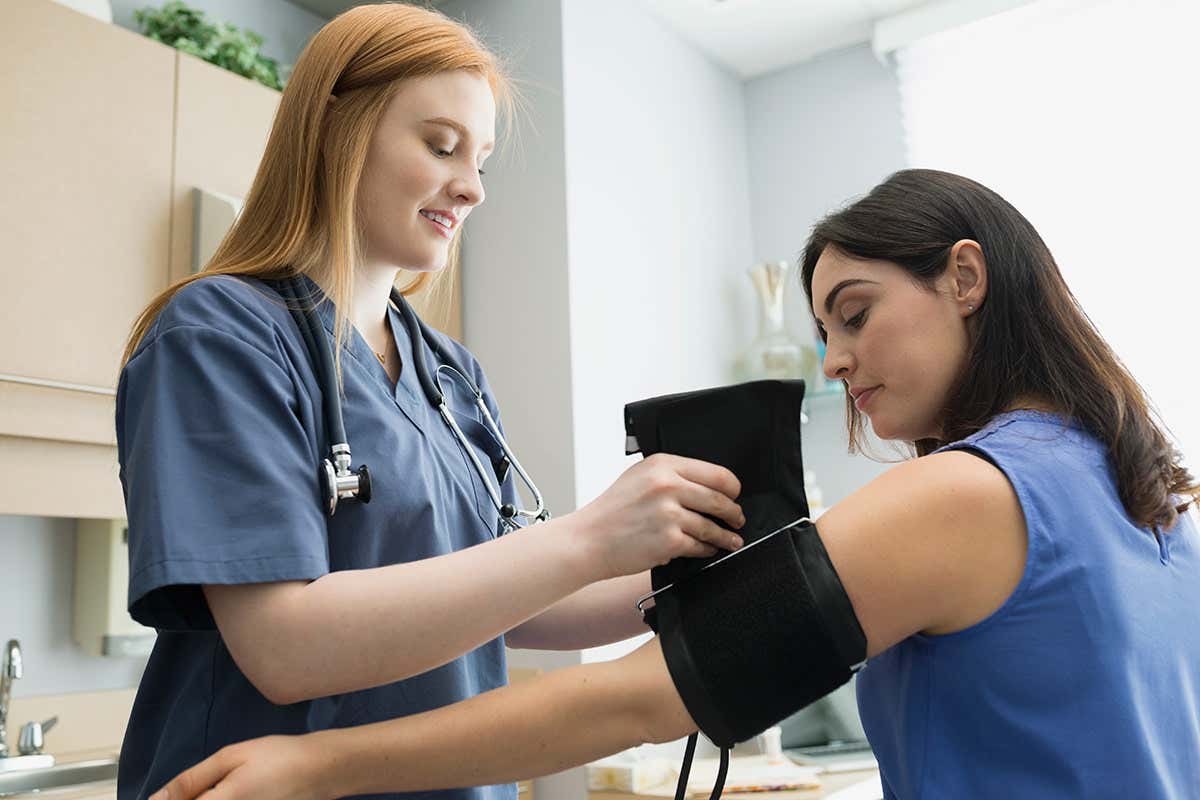 A woman having her blood pressure taken