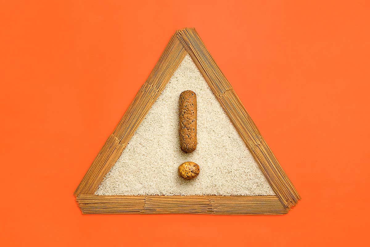 Warning symbol made of a sausage with a rice background