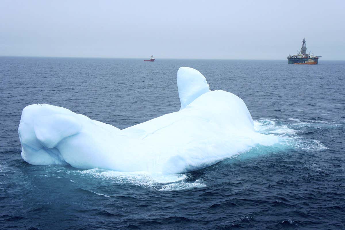 An iceberg near an oil rig