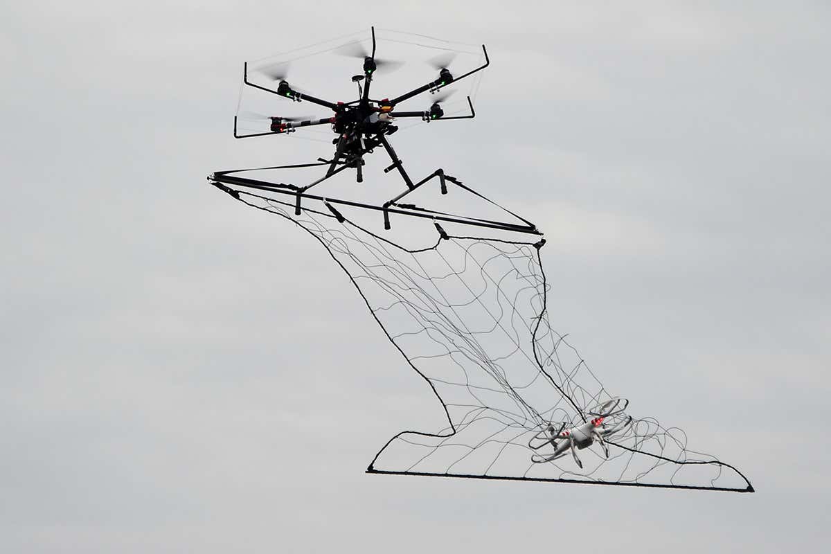 A police drone interceptor snags another drone with a net during an anti-terrorism drill for theTokyo marathon