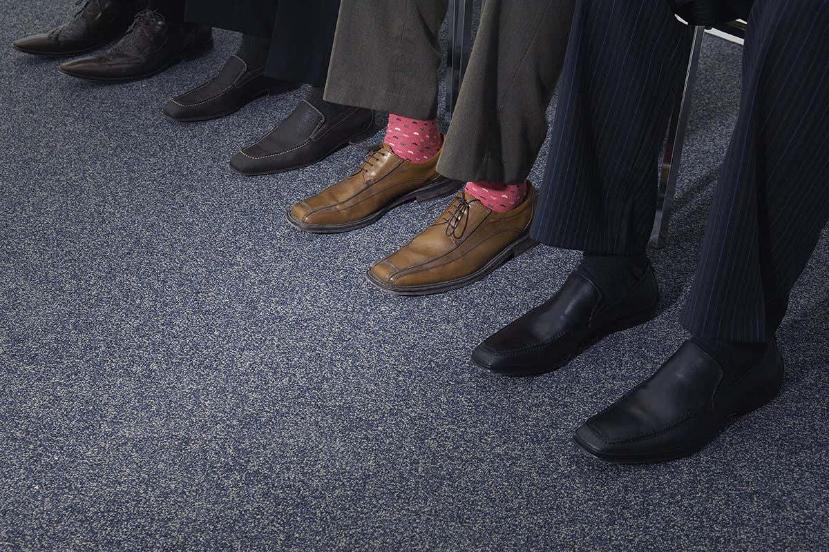 Row of feet with one person wearing bright socks