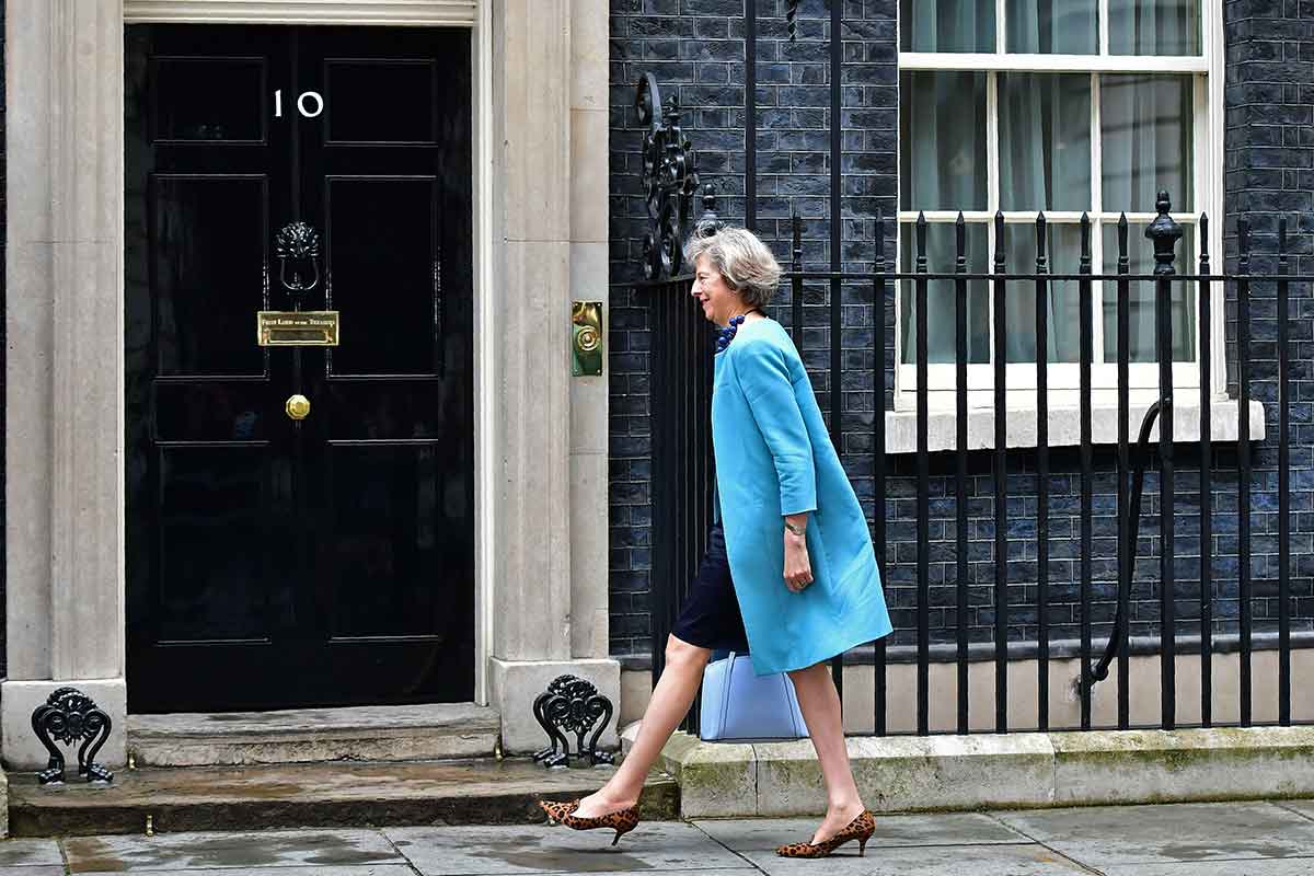 Theresa May walking towards the door of Number 10 Downing Street