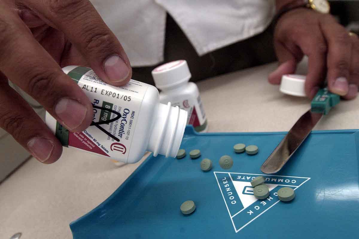 Person empties out bottle of the painkiller OxyContin