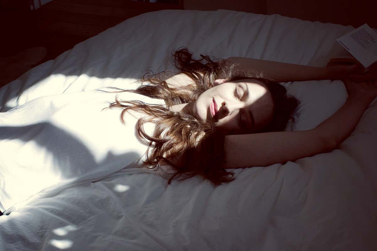 A woman sleeping with a shaft of light falling on her