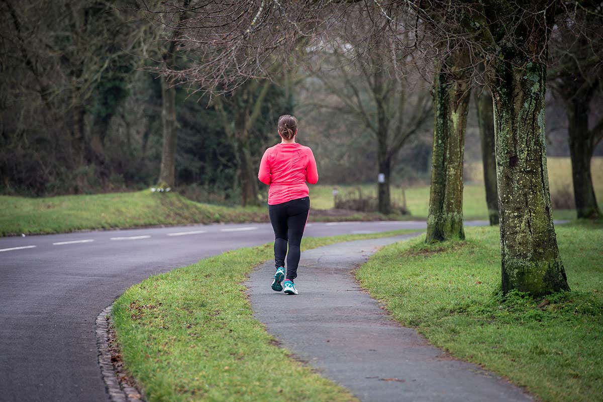 A woman jogging along a road