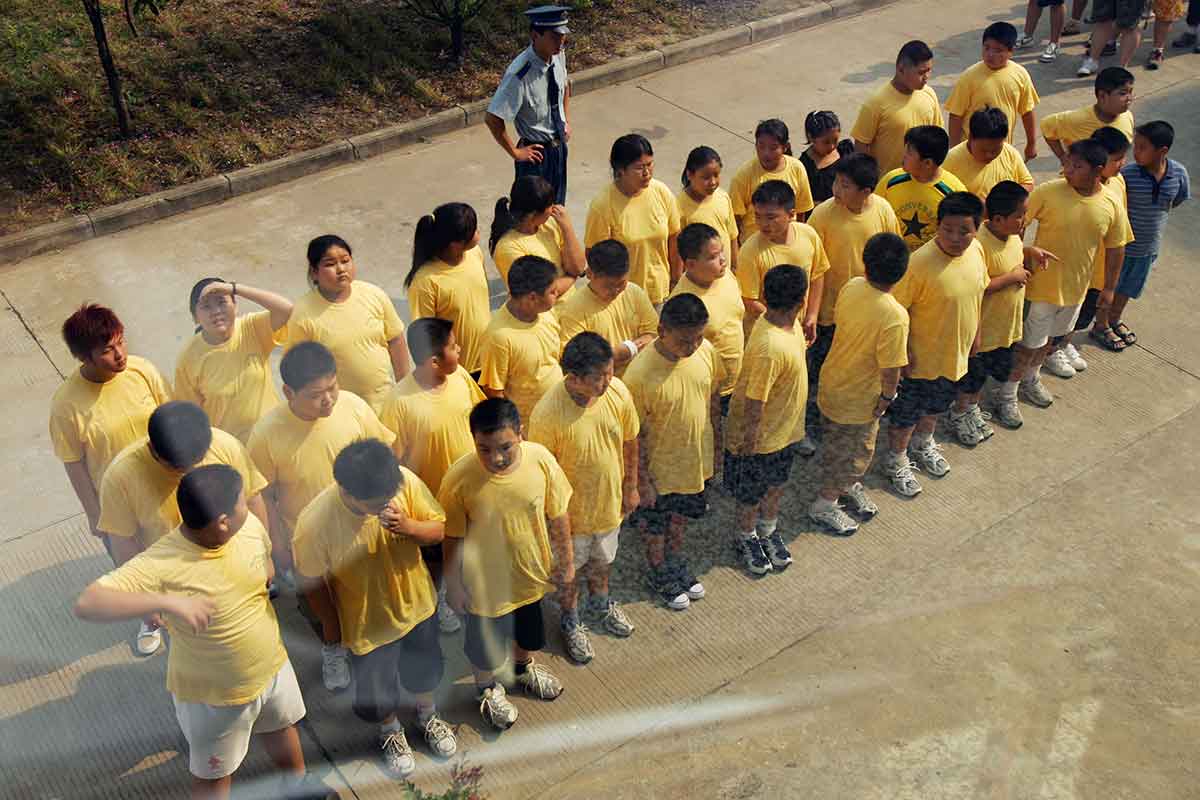 A group of young Chinese people, most of whom appear to be overweight