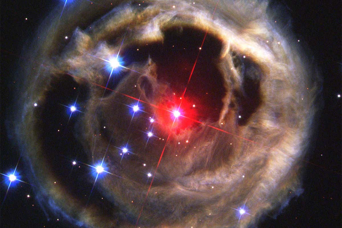 Red star surrounded by ordinary white stars. V838 Monocerotis, another red nova which erupted in 2002