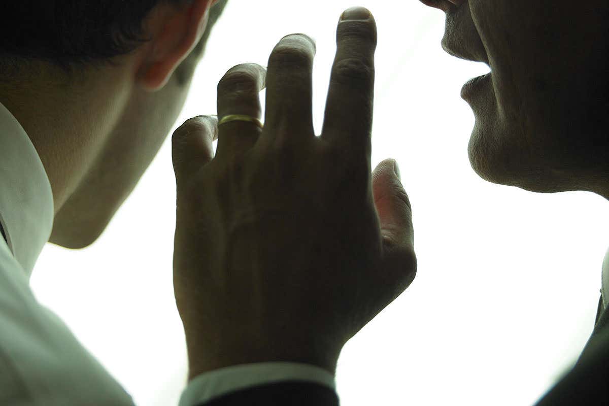 A person speaking close to someone else's ear