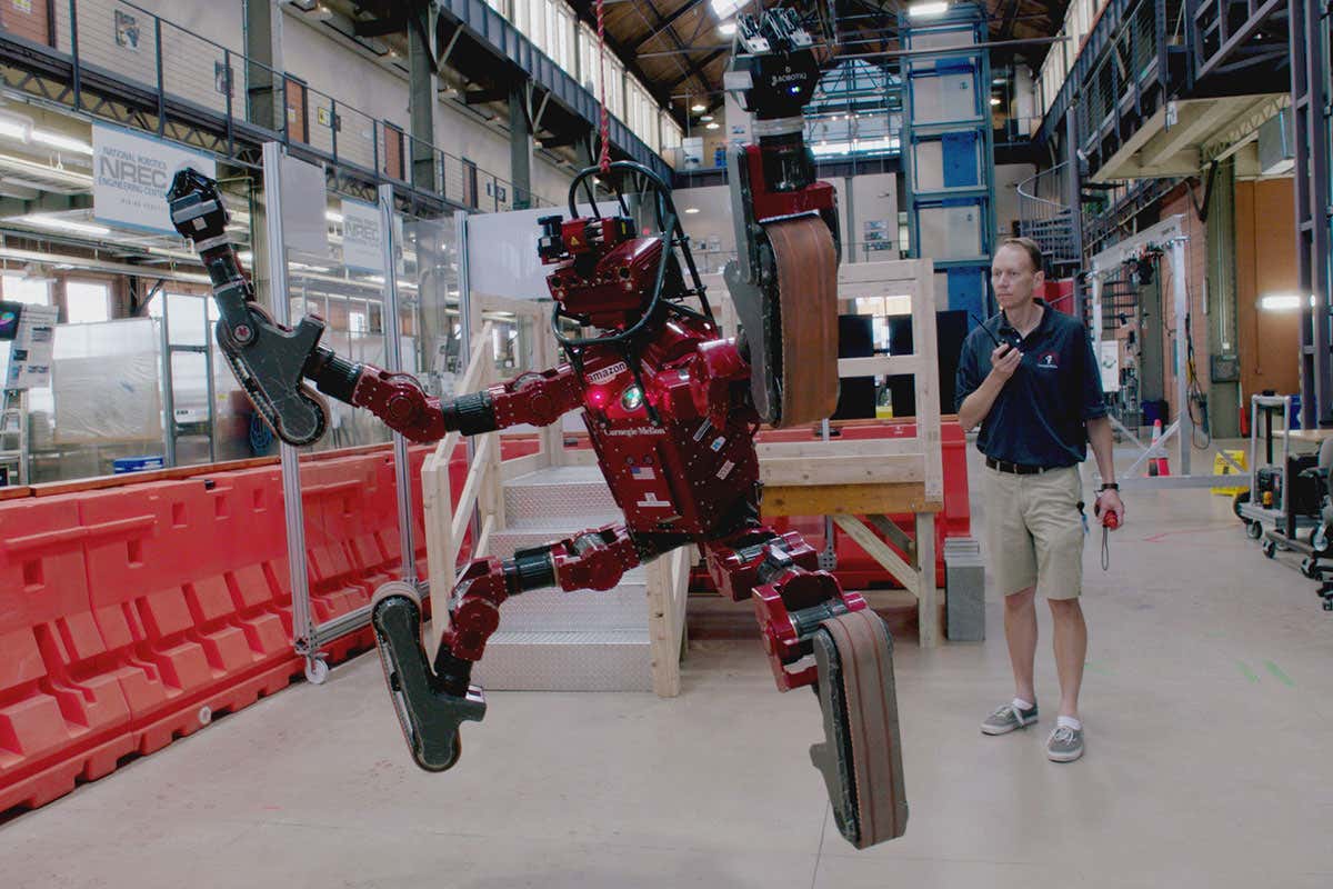 Man with robot, a scene from Lo and Behold