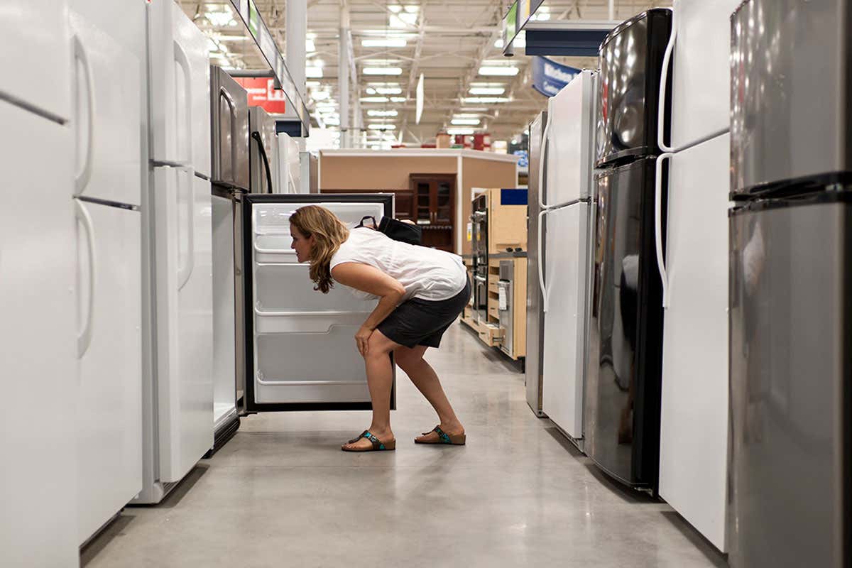 Woman looking into a large fridge