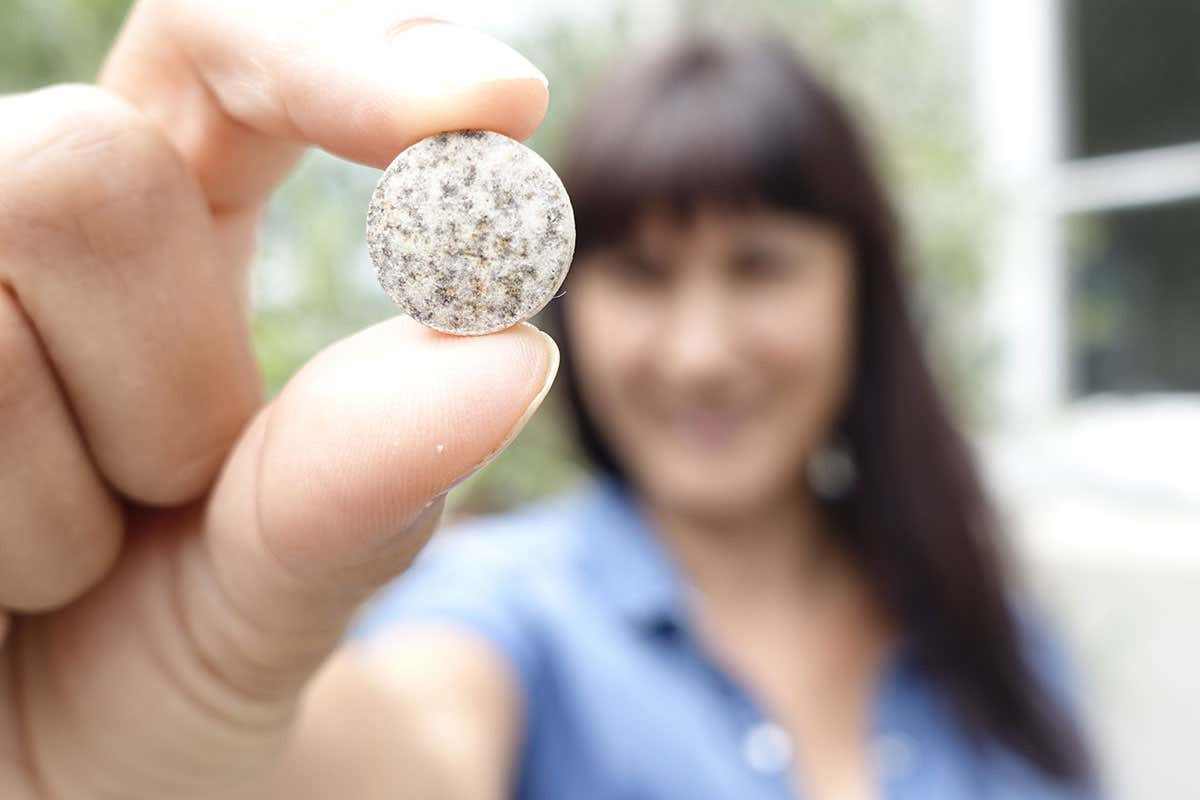 Woman holding tablet in outstretched hand