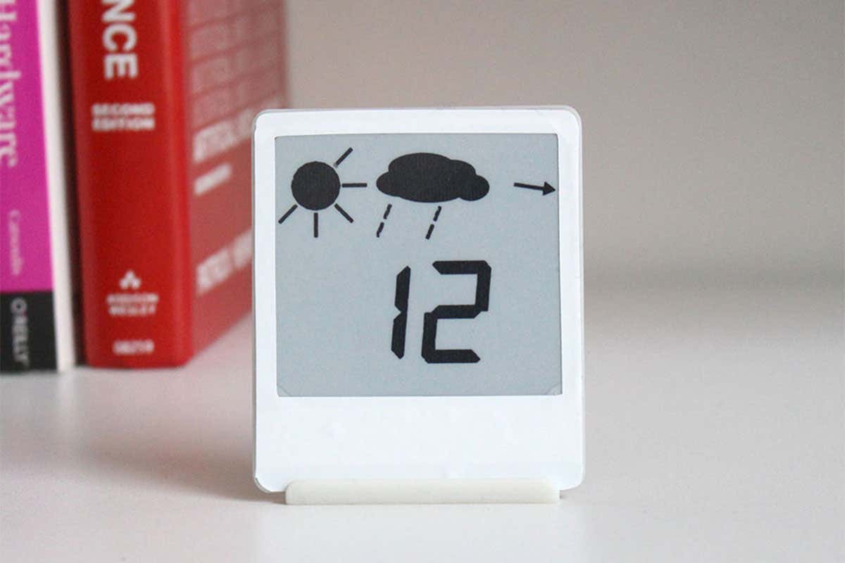 An e-reader screen the size of a Post-it note with a white border stands on a desk