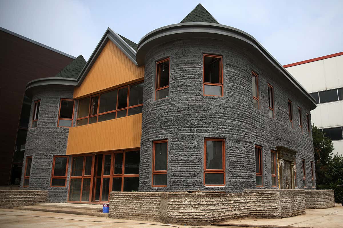 A large, grey two-floor house