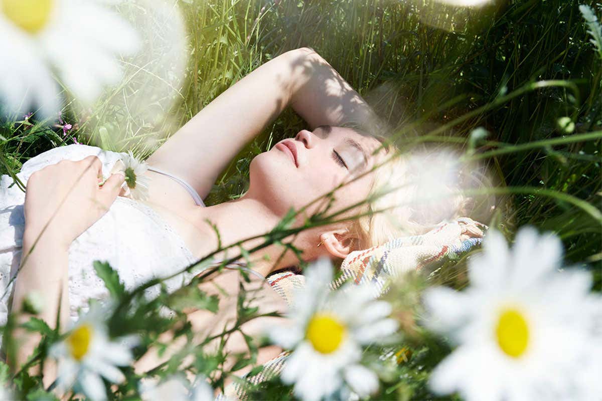 Woman sleeping in meadow