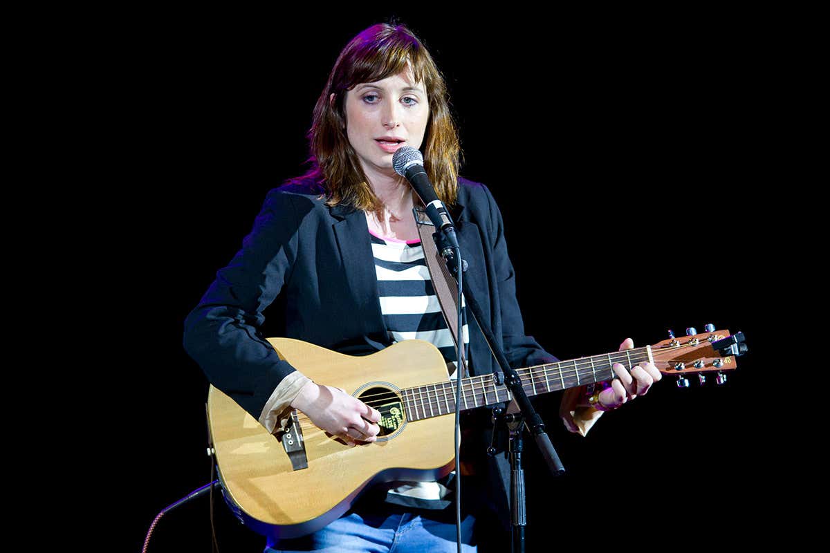 Isy Suttie, who experiences the tingly feelings of ASMR, playing guitar and singing
