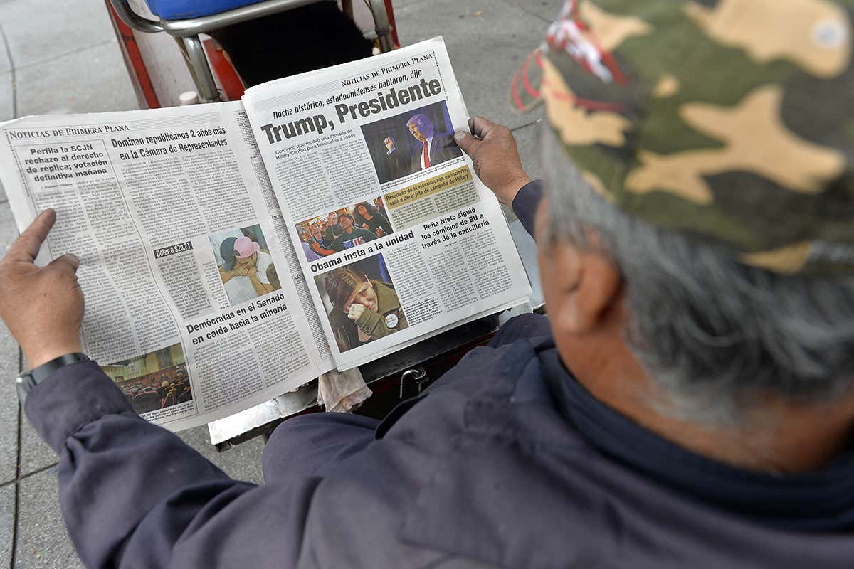 Man reads about Trump's victory in paper