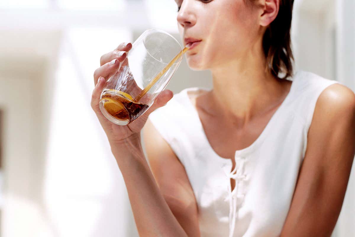A woman drinking a fizzy drink