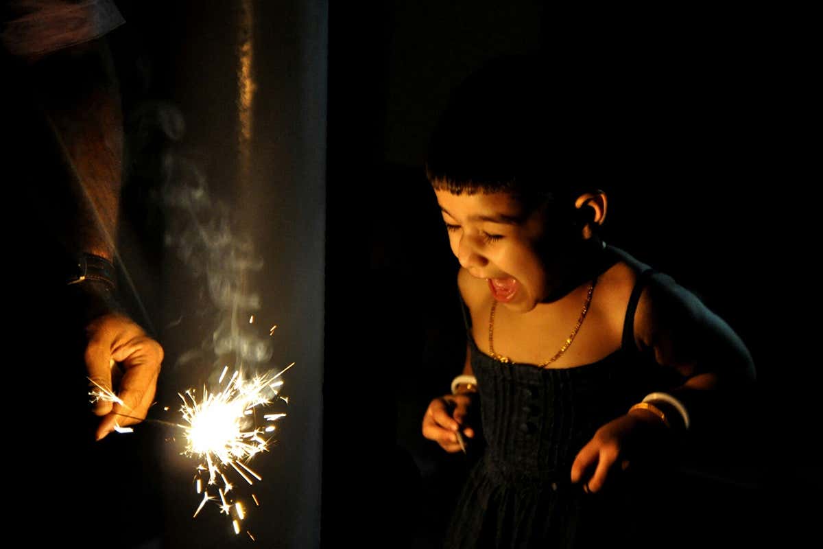 Child watching a sparkler