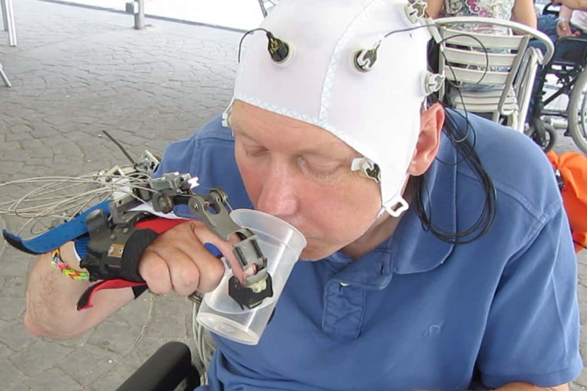 Paralysed man drinking using robot hand