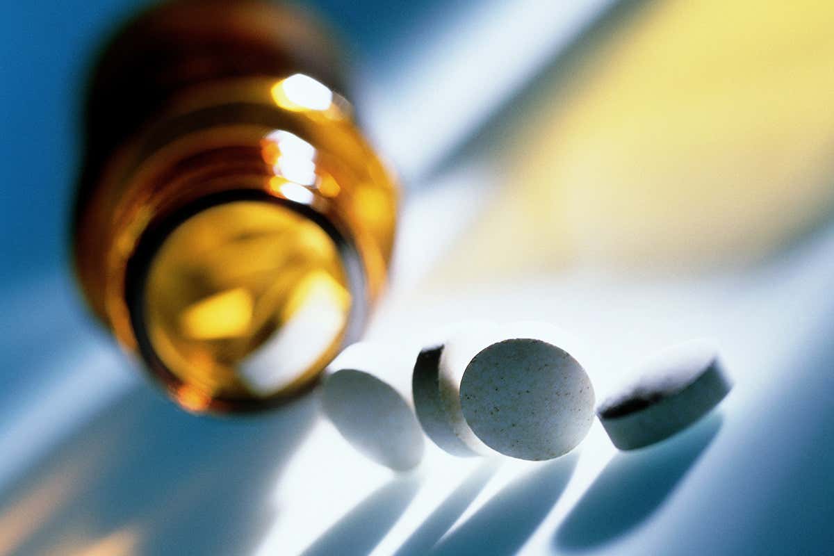 Pain killer pills spilling out of a bottle