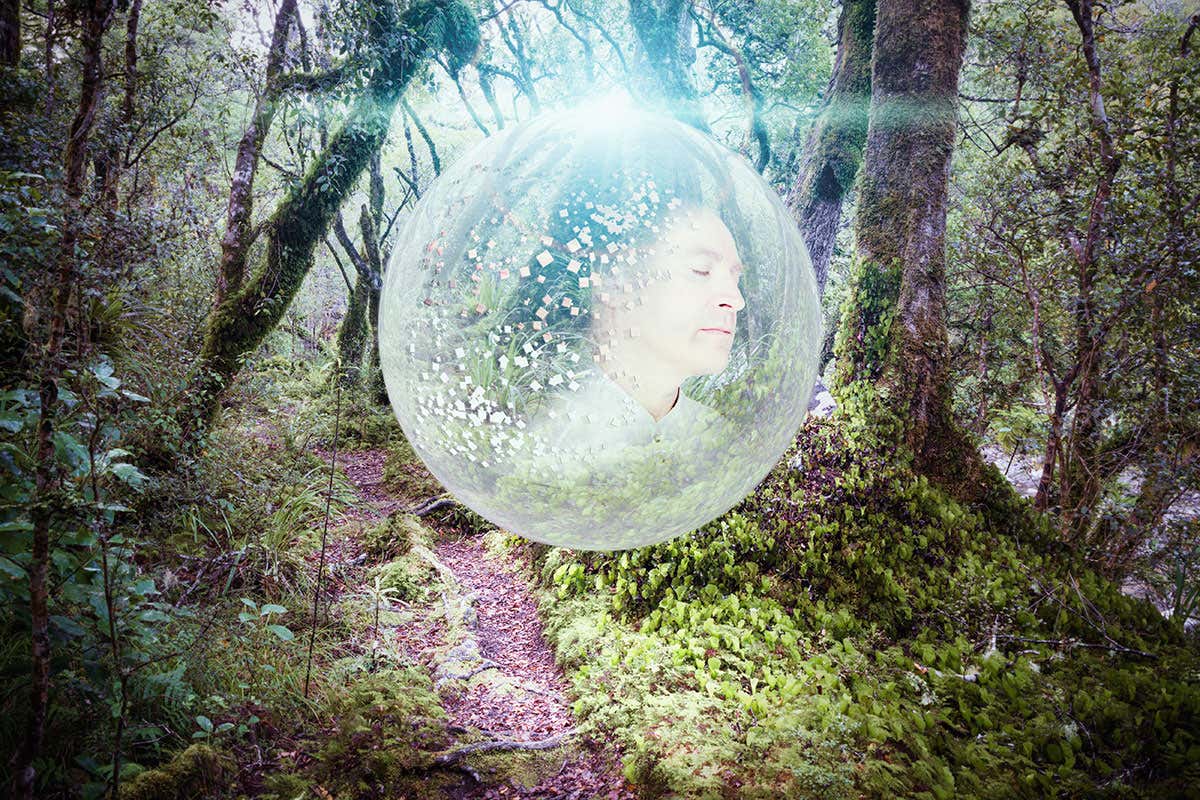 Man in bubble floating through forest
