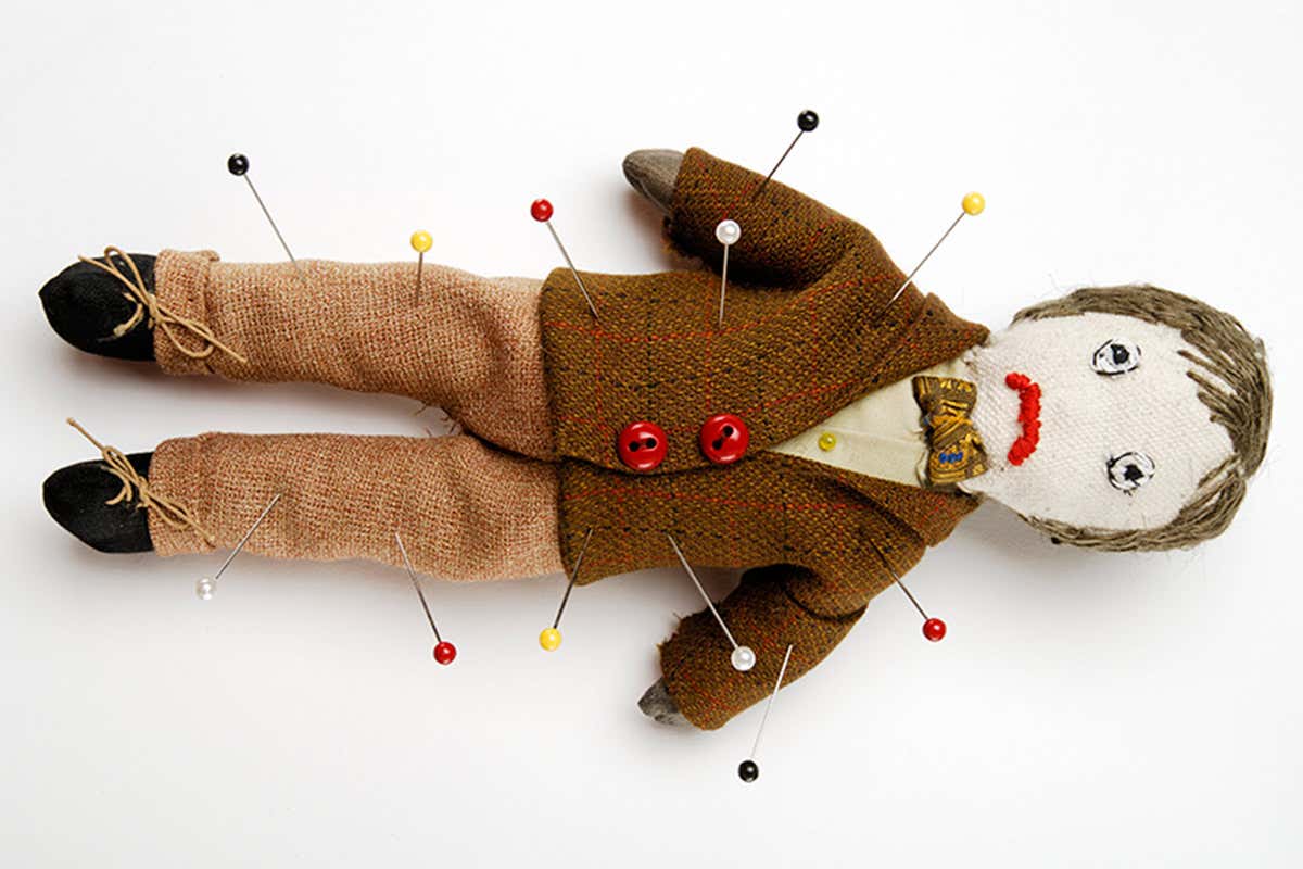 Doll with pins stuck in it
