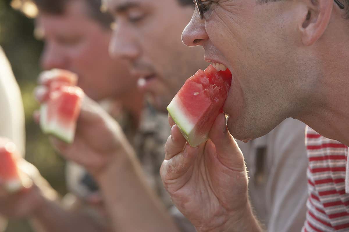 People eating watermelons together