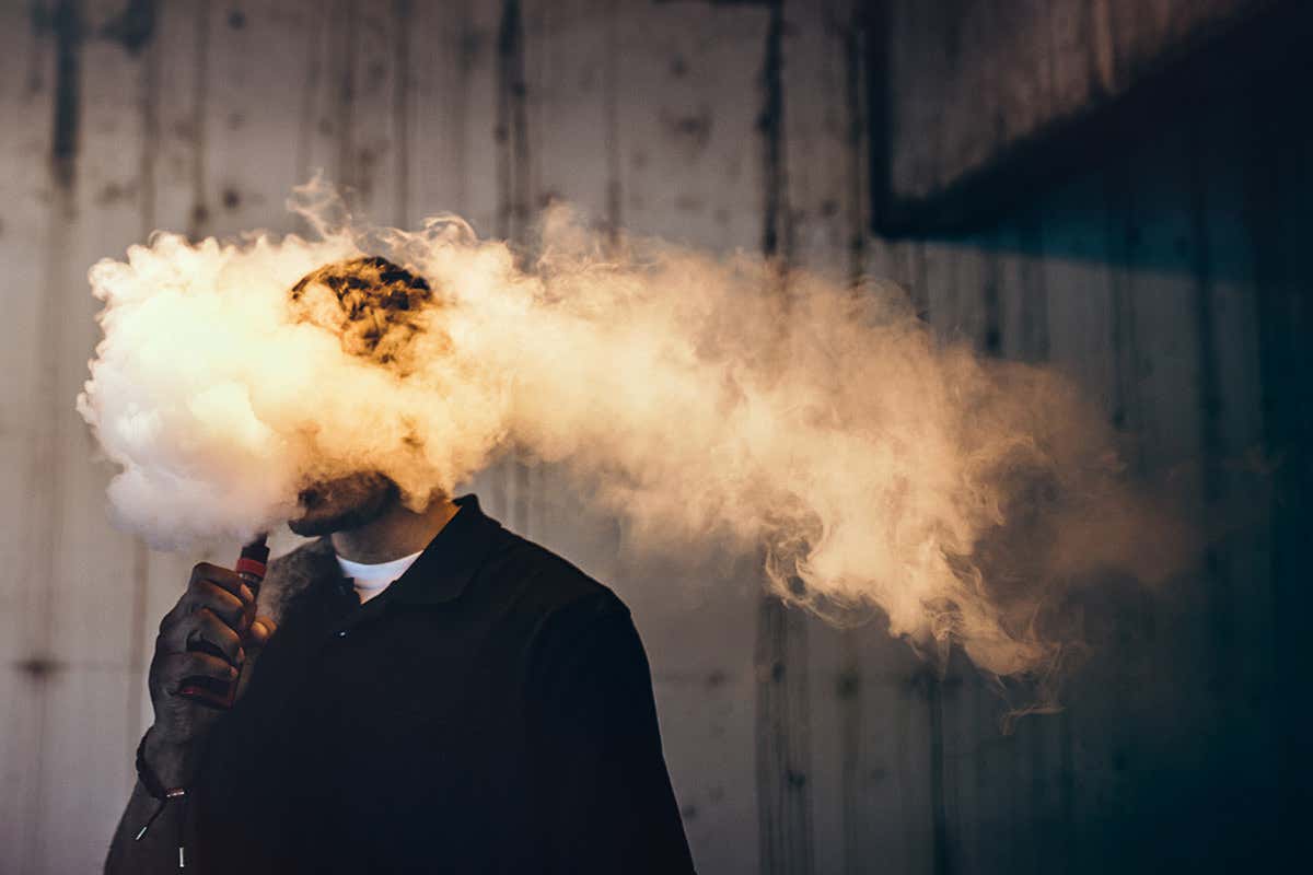 A man smoking an e-cigarette