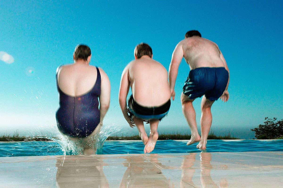 Family leaps into swimming pool together