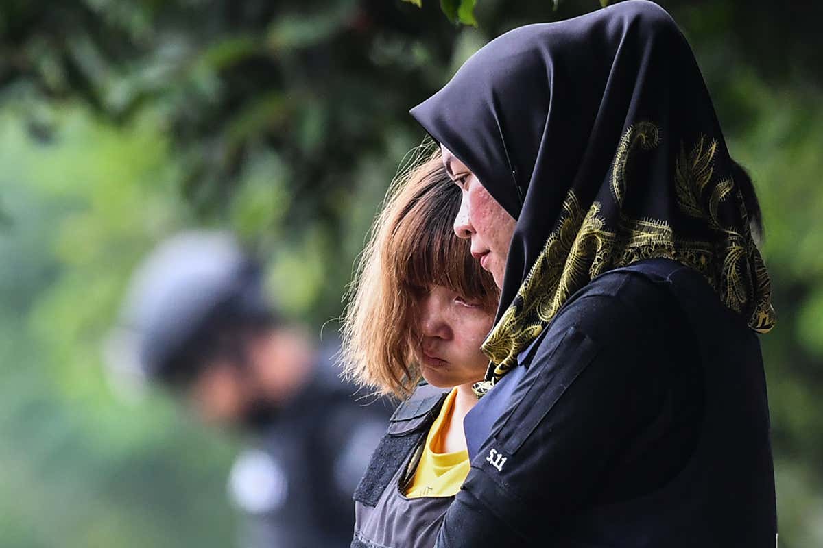 One of the accused women being escorted to court