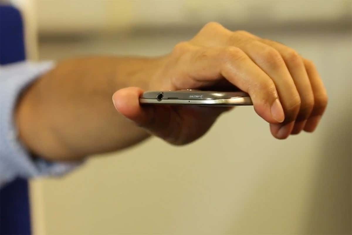 Arm extended horizontally while gripping phone