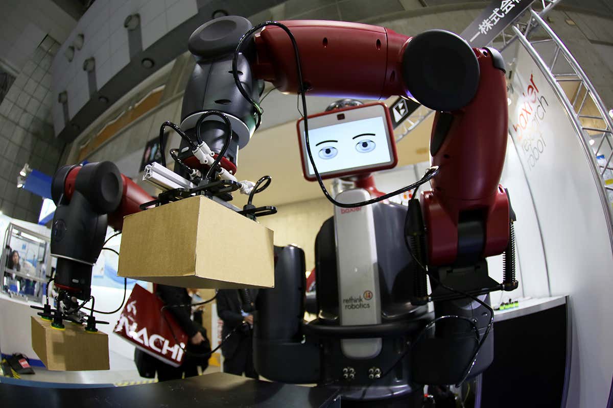 A Baxter robot moving a box with its arm