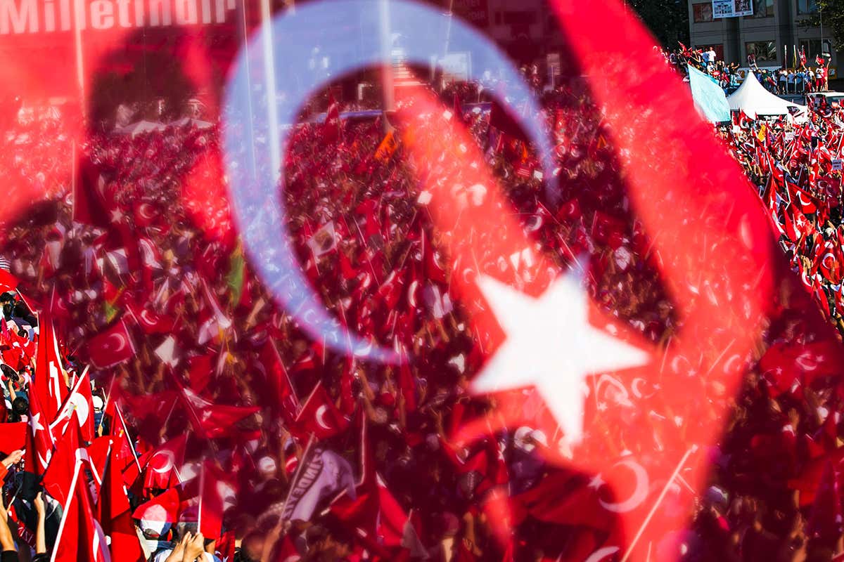 Crowd seen through Turkish flag