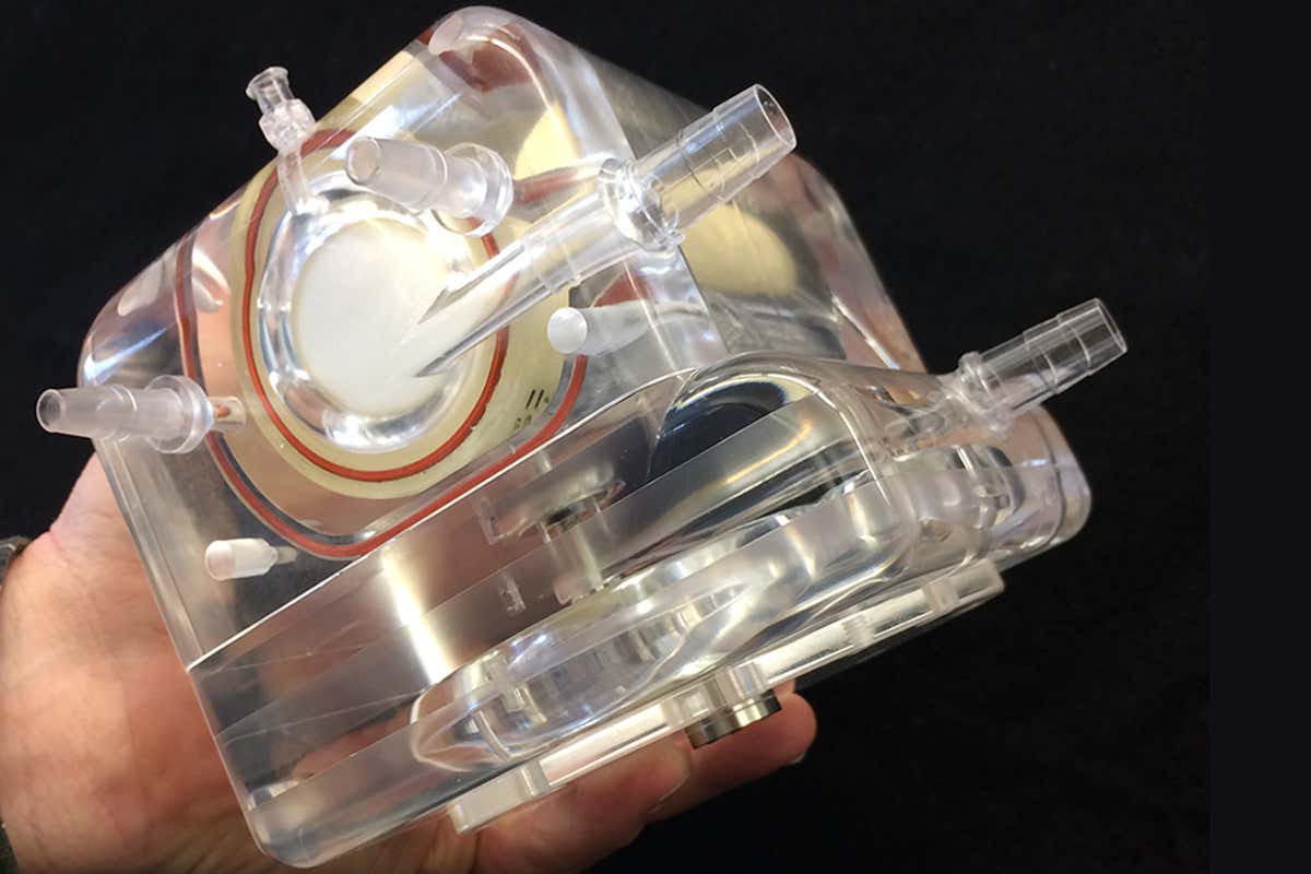 The artificial lung device being held in one hand