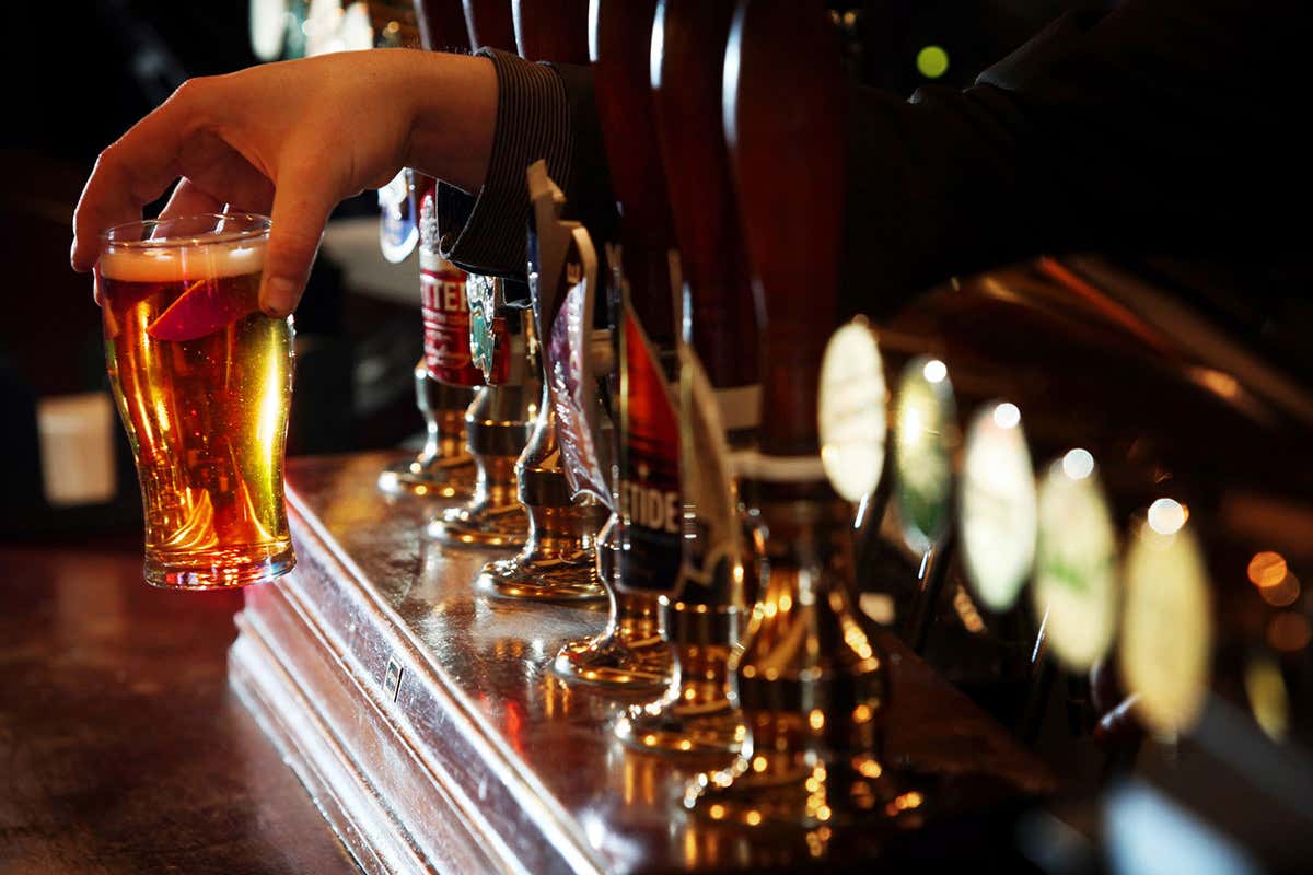 A pint of beer being served in a bar