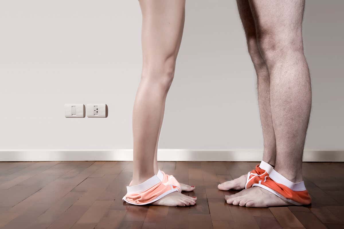 Two pairs of bare legs facing each other, underwear around their ankles