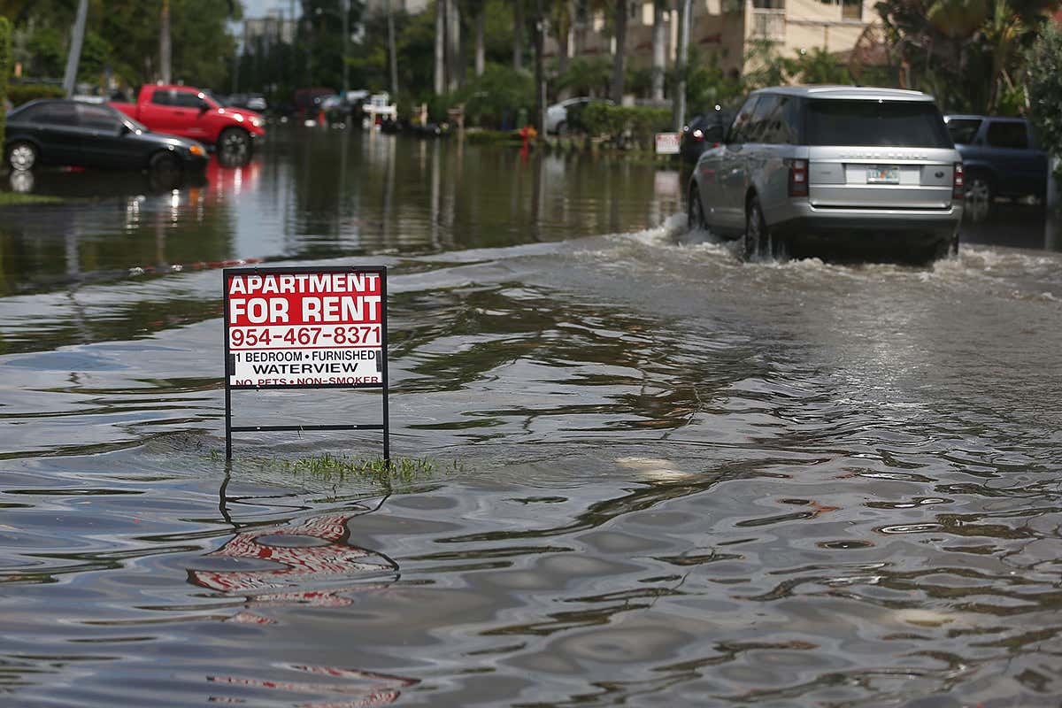 Sign advertising property to rent on flooded street