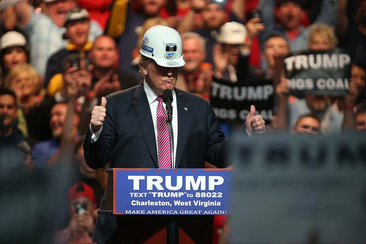 President Trump wearing a hard hat while giving a speech