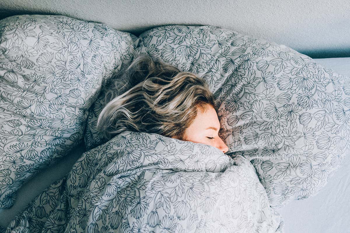 A woman sleeping in a bed