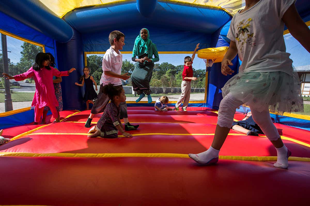 Children playing on a bouncy castle